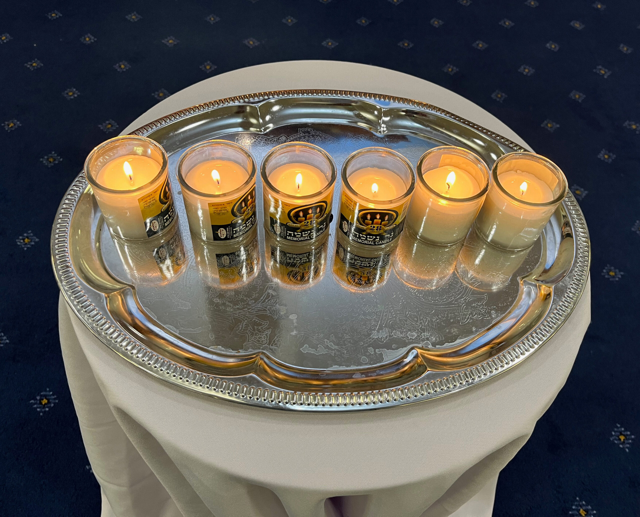 6 Memorial Candles in memory of the 6 million Jewish victims of the holocaust lit by the 5th North Finchley guides and the 20th North Finchley Scouts