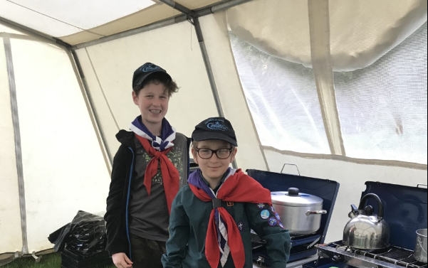 Scouts cooking in a tent
